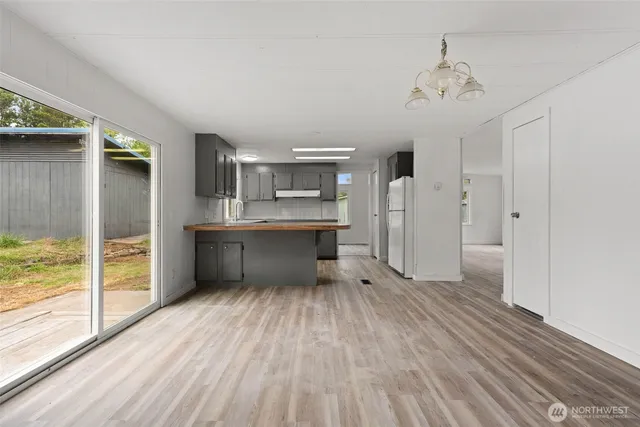 a kitchen with a refrigerator and window