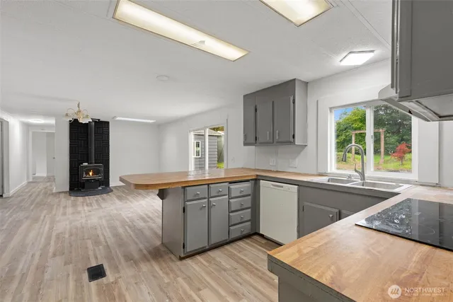 a kitchen with wooden floors and wooden cabinets