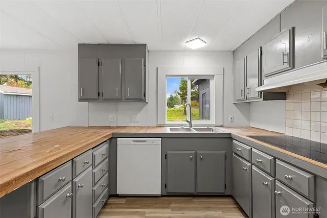a kitchen with a sink stove and cabinets