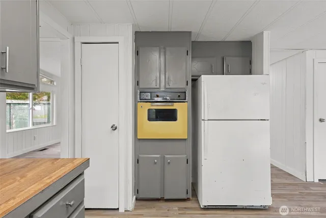 a kitchen with a refrigerator and a stove
