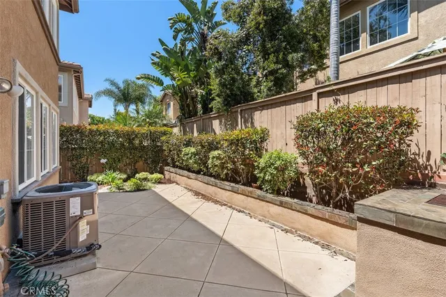 a view of a balcony with wooden fence and potted plants