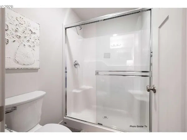 a bathroom with a shower and a toilet
