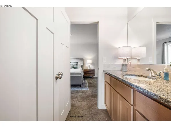a kitchen with a sink dishwasher a refrigerator and a stove with wooden floor