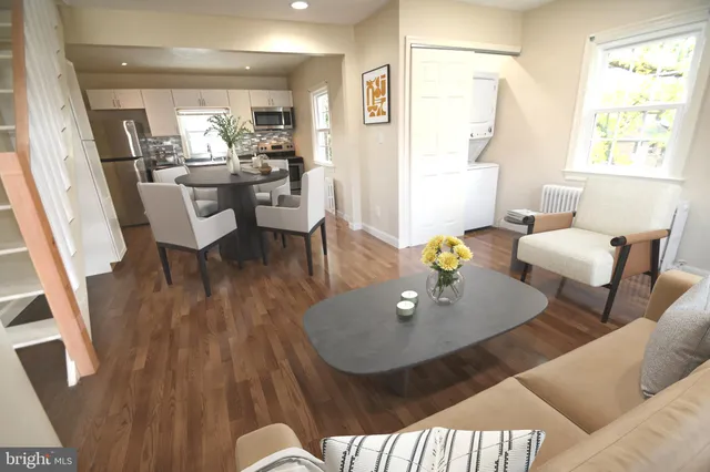 a spacious bedroom with a bed a couch and a window