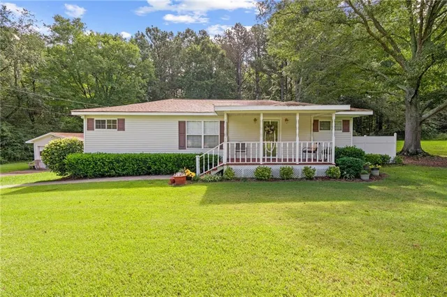 a front view of house with yard and green space