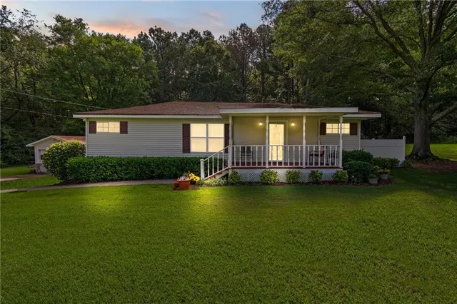 a front view of a house with swimming pool having outdoor seating
