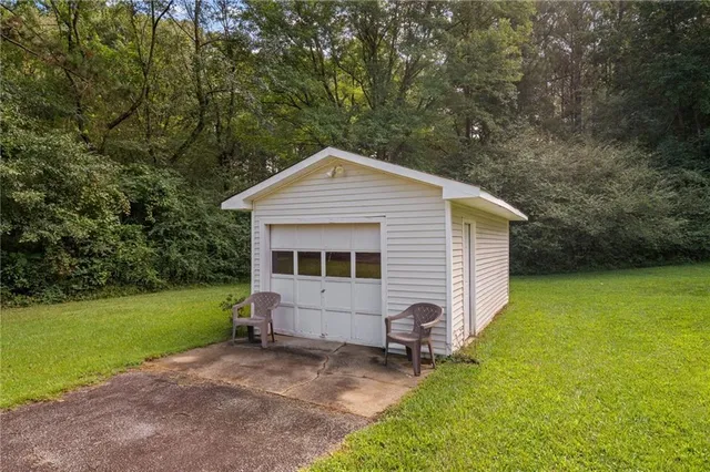 an aerial view of residential houses with outdoor space and trees