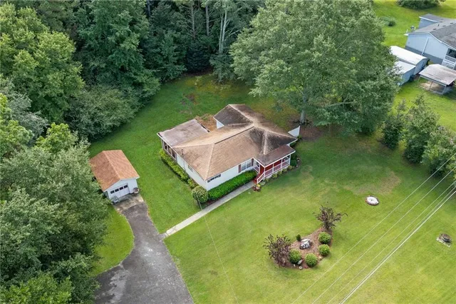 an aerial view of a house with a yard