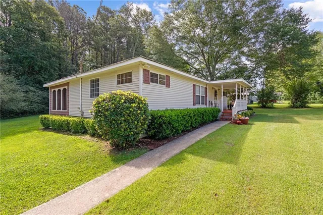 a front view of a house with garden