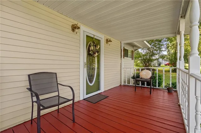 a view of empty room with wooden floor and fireplace