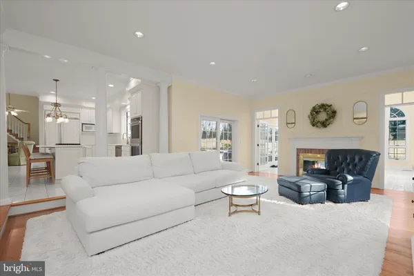 a dining hall with stainless steel appliances a dining table and chairs with kitchen island