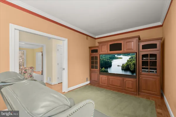 a living room with furniture a rug and a chandelier