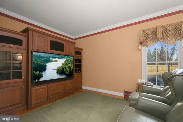 a living room with furniture and a lamp