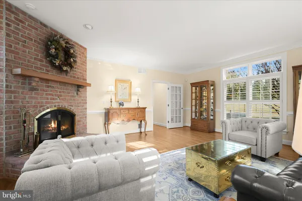 a kitchen with stainless steel appliances granite countertop a sink a refrigerator and a wooden floor