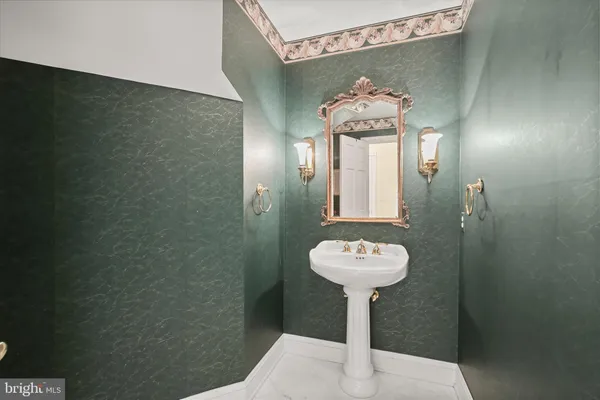 a bathroom with a sink toilet and a mirror