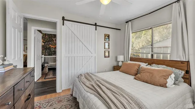 a bedroom with a large bed and a window