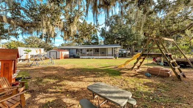 a view of a backyard with table and chairs