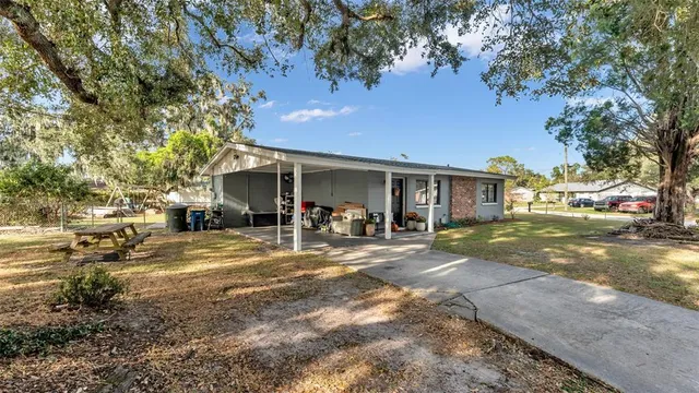 a view of a garage with a table and chairs and potted plants