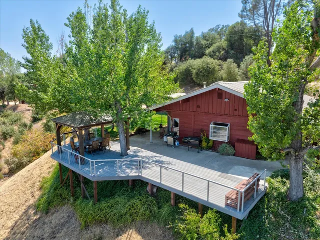 an aerial view of a house with swimming pool garden view and trees