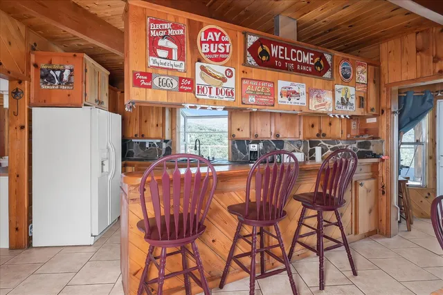 a kitchen with granite countertop a sink stove and cabinets