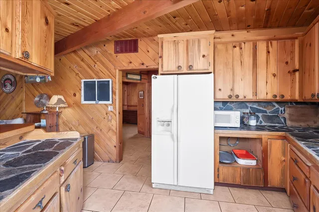a view of a kitchen with kitchen island granite countertop a sink