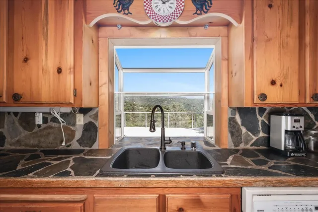 a view of a patio with a table and chairs
