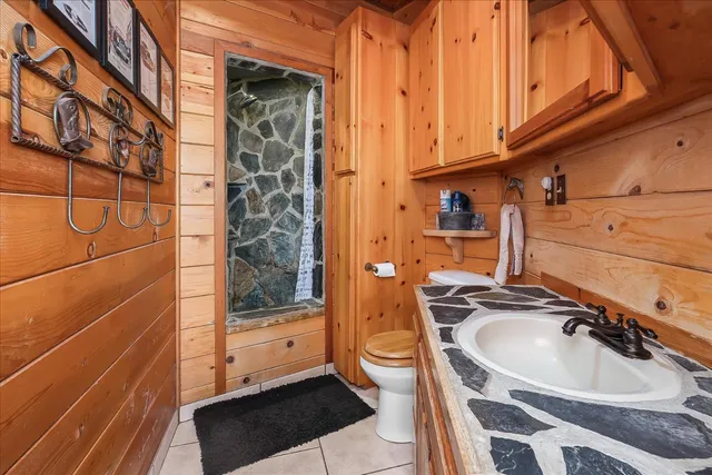 a bathroom with a shower and a glass door
