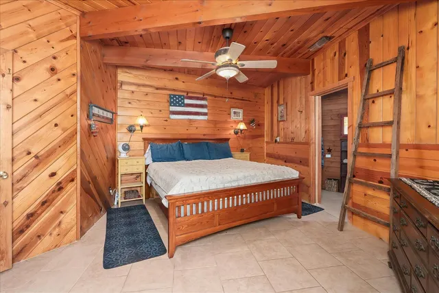 a bed sitting in a bedroom next to a window