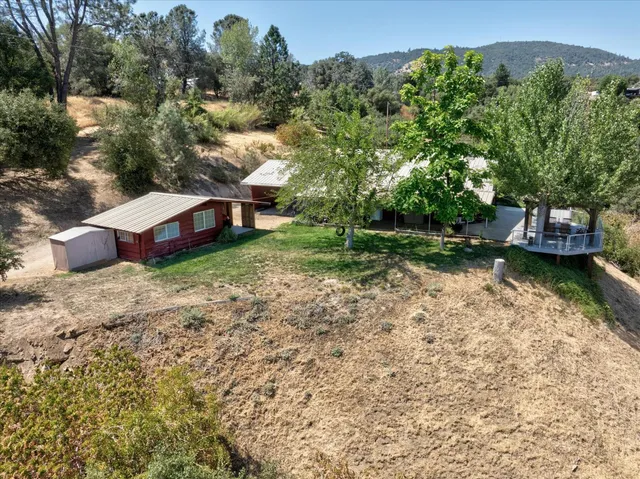 a view of a house with a yard and sitting area