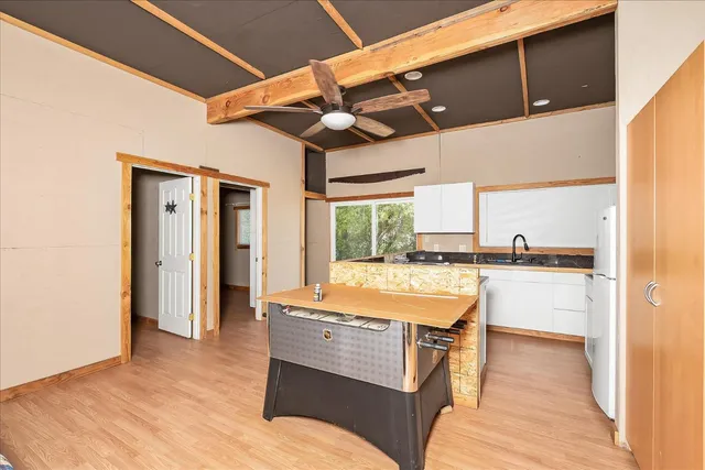 a view of a hallway with wooden floor and closet