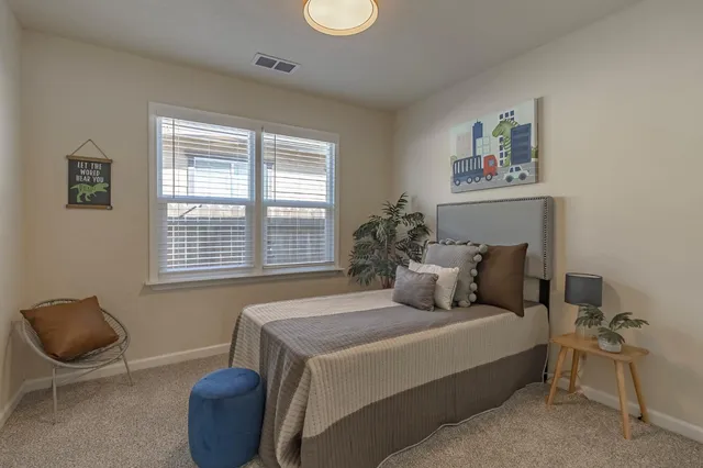 a bedroom with a bed and chair