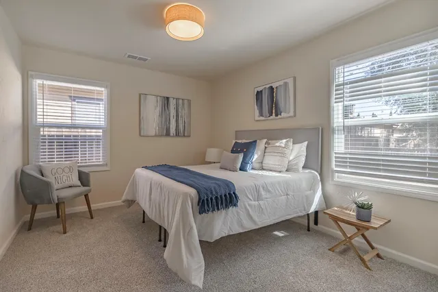 a bedroom with a bed and chair