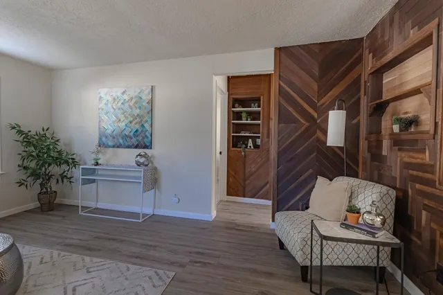 a living room with furniture and a potted plant