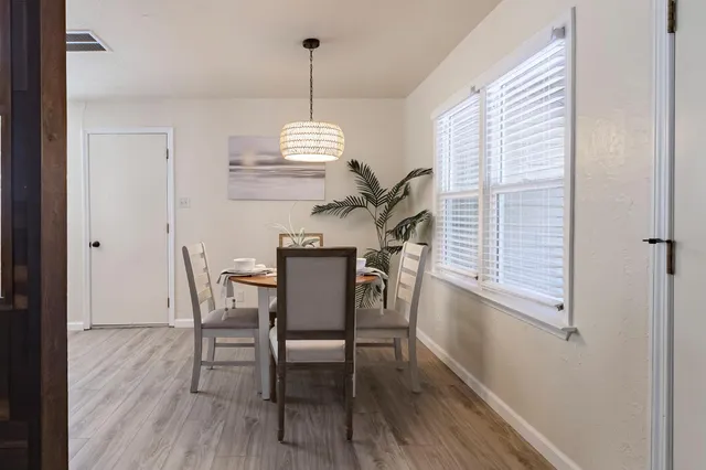 a view of a dining room with furniture window and wooden floor