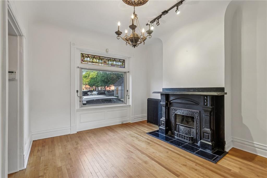 1218 Sherman Avenue Pittsburgh, PA 15212 - Photo 12 of 48 wooden floor fireplace and windows in an empty room