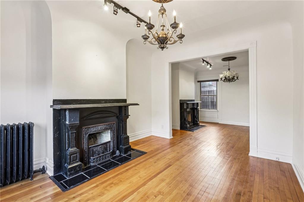 1218 Sherman Avenue Pittsburgh, PA 15212 - Photo 13 of 48 a view of a livingroom with a fireplace and wooden floor