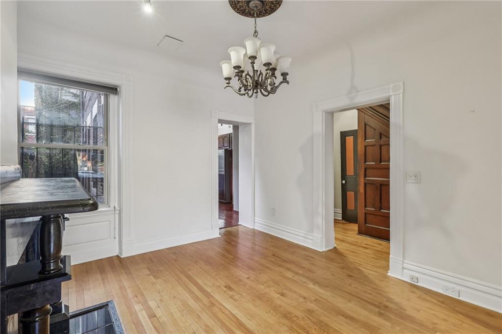 1218 Sherman Avenue Pittsburgh, PA 15212 - Photo 17 of 48 a view of a room with wooden floor and chandelier