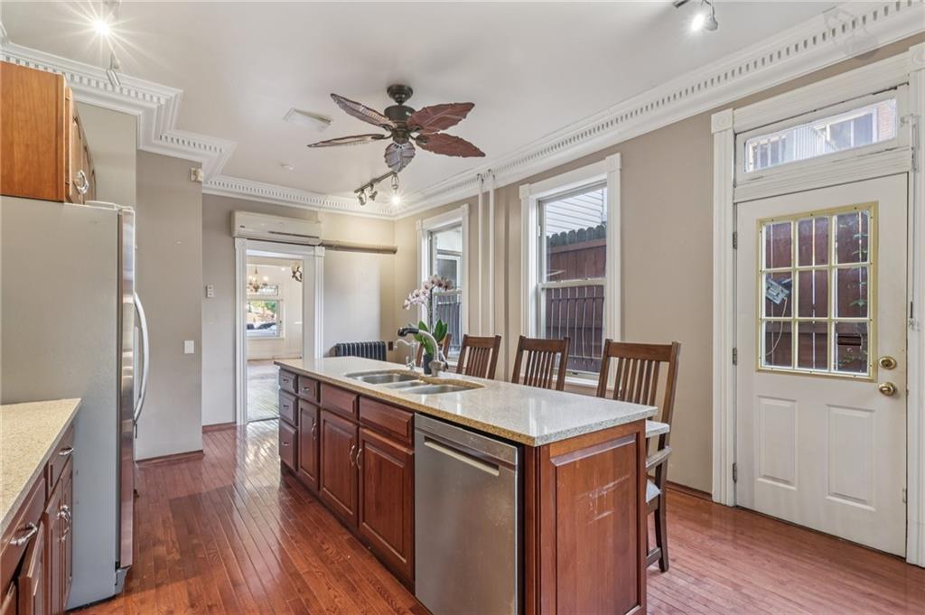 1218 Sherman Avenue Pittsburgh, PA 15212 - Photo 19 of 48 a kitchen with a stove a refrigerator a sink dishwasher with wooden floor and cabinets