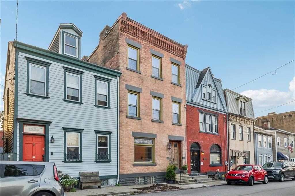 1218 Sherman Avenue Pittsburgh, PA 15212 - Photo 2 of 48 a front view of a building with lot of cars and trees
