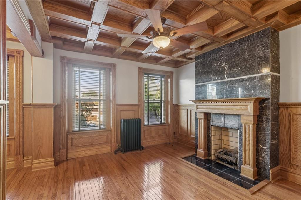 1218 Sherman Avenue Pittsburgh, PA 15212 - Photo 27 of 48 a view of an empty room with wooden floor fireplace and a window