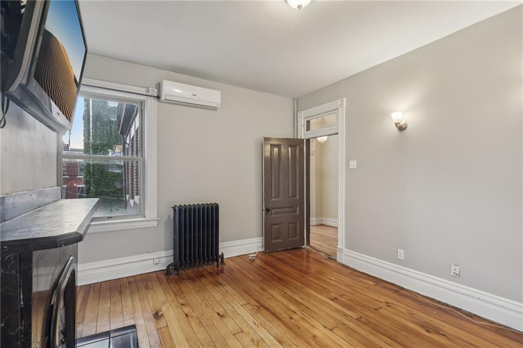 1218 Sherman Avenue Pittsburgh, PA 15212 - Photo 29 of 48 a view of an empty room with wooden floor and a window