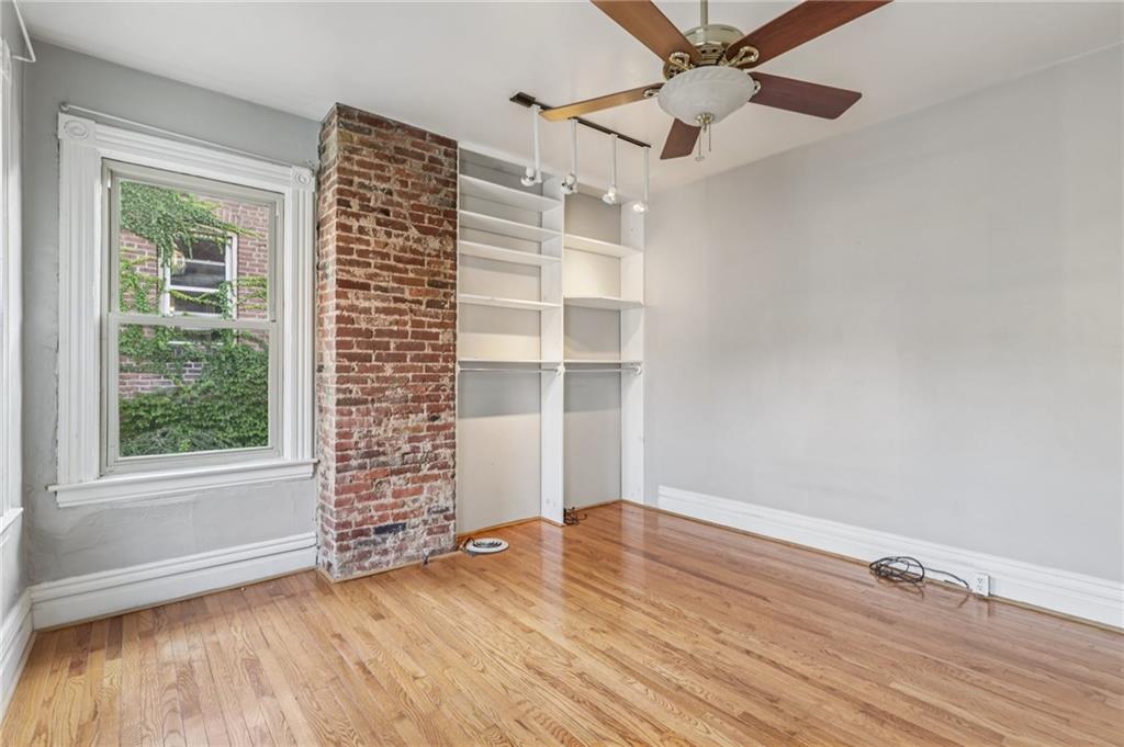 1218 Sherman Avenue Pittsburgh, PA 15212 - Photo 33 of 48 a view of an empty room with a window and wooden floor