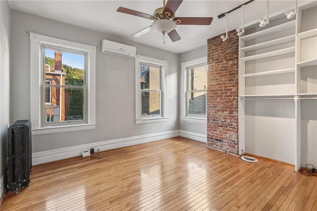 1218 Sherman Avenue Pittsburgh, PA 15212 - Photo 34 of 48 a view of an empty room with a window and wooden floor