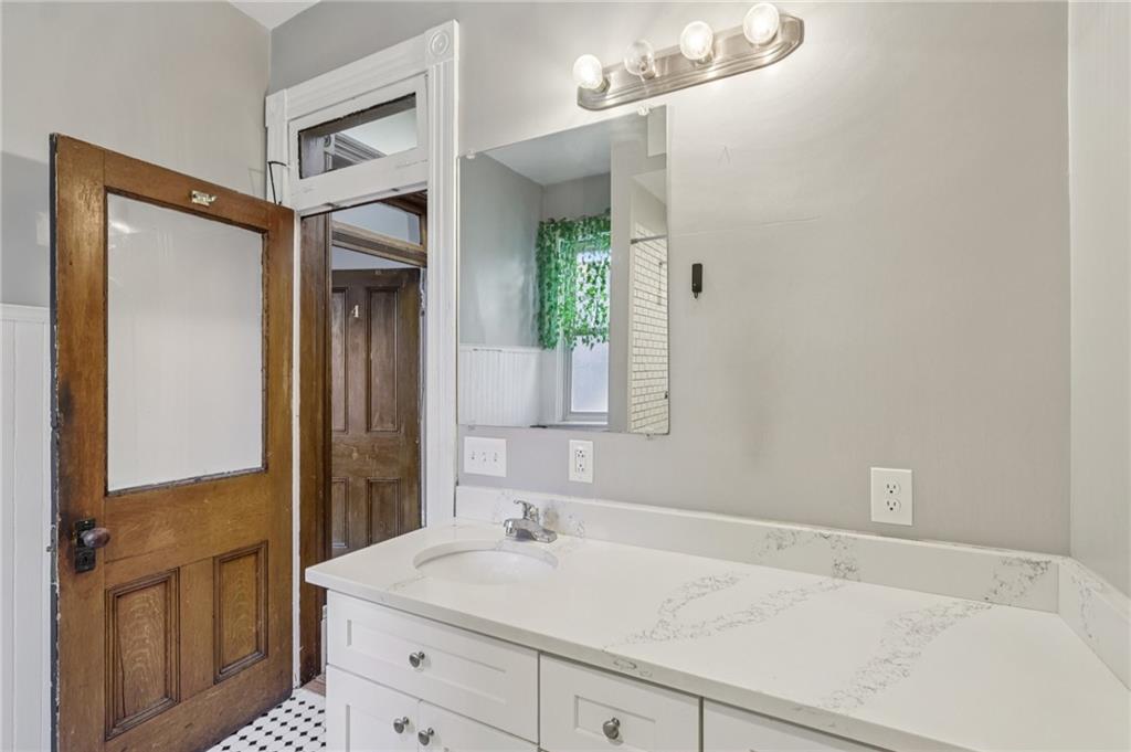 1218 Sherman Avenue Pittsburgh, PA 15212 - Photo 35 of 48 a bathroom with a sink and a mirror