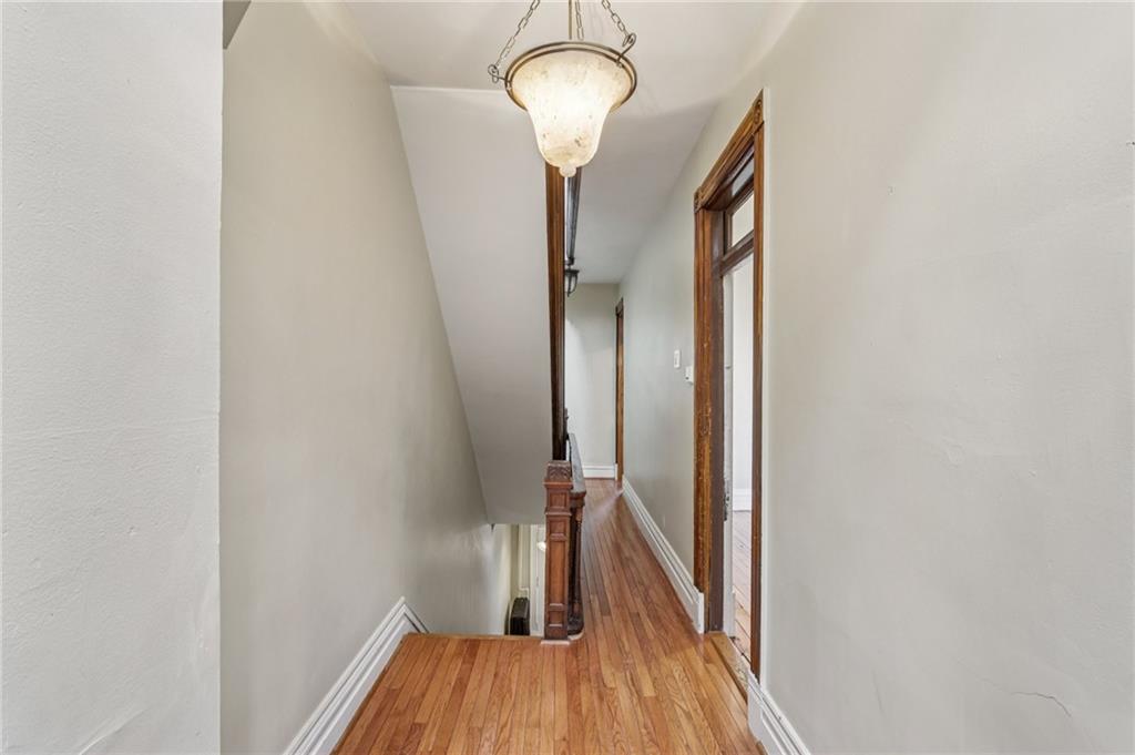1218 Sherman Avenue Pittsburgh, PA 15212 - Photo 38 of 48 a view of a hallway with wooden floor and staircase