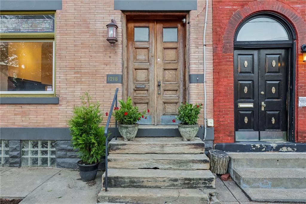1218 Sherman Avenue Pittsburgh, PA 15212 - Photo 7 of 48 a front view of a house with a garden