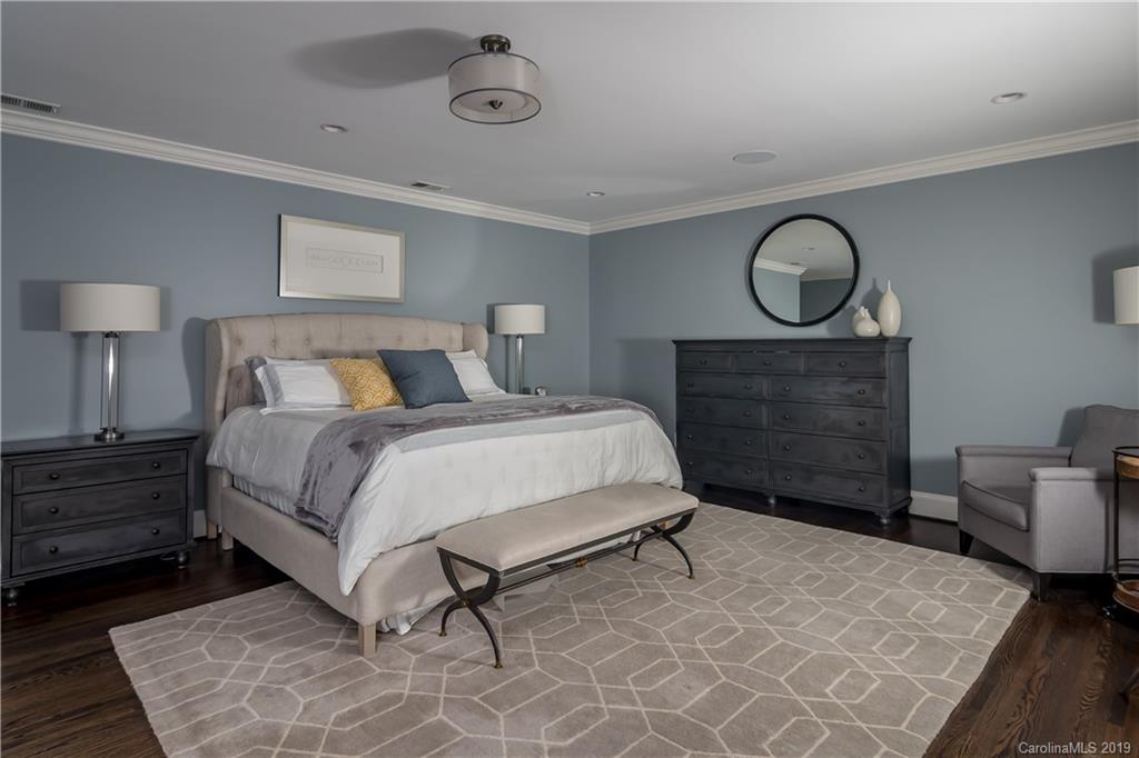 2634 Sharon Road Charlotte, NC 28211 - Photo 21 of 46 a bedroom with a bed and wooden floor