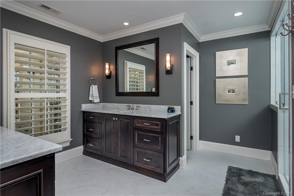 2634 Sharon Road Charlotte, NC 28211 - Photo 22 of 46 a bathroom with a sink a vanity and a mirror