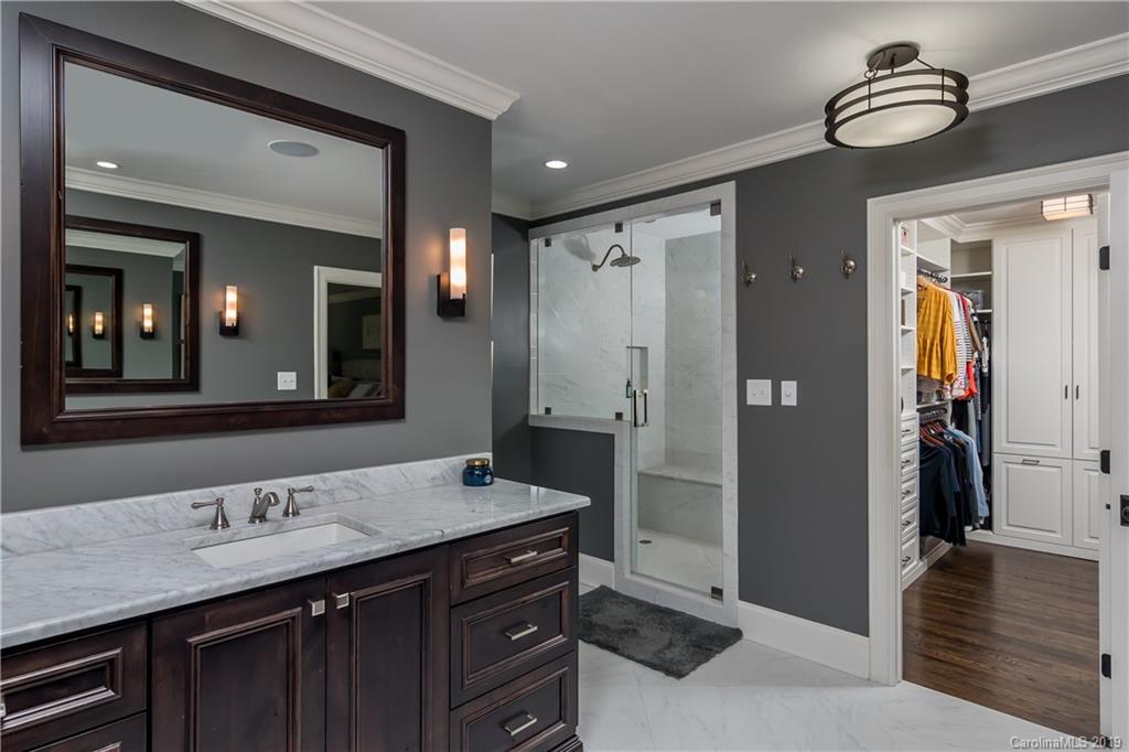 2634 Sharon Road Charlotte, NC 28211 - Photo 24 of 46 a bathroom with a sink a double vanity and a mirror