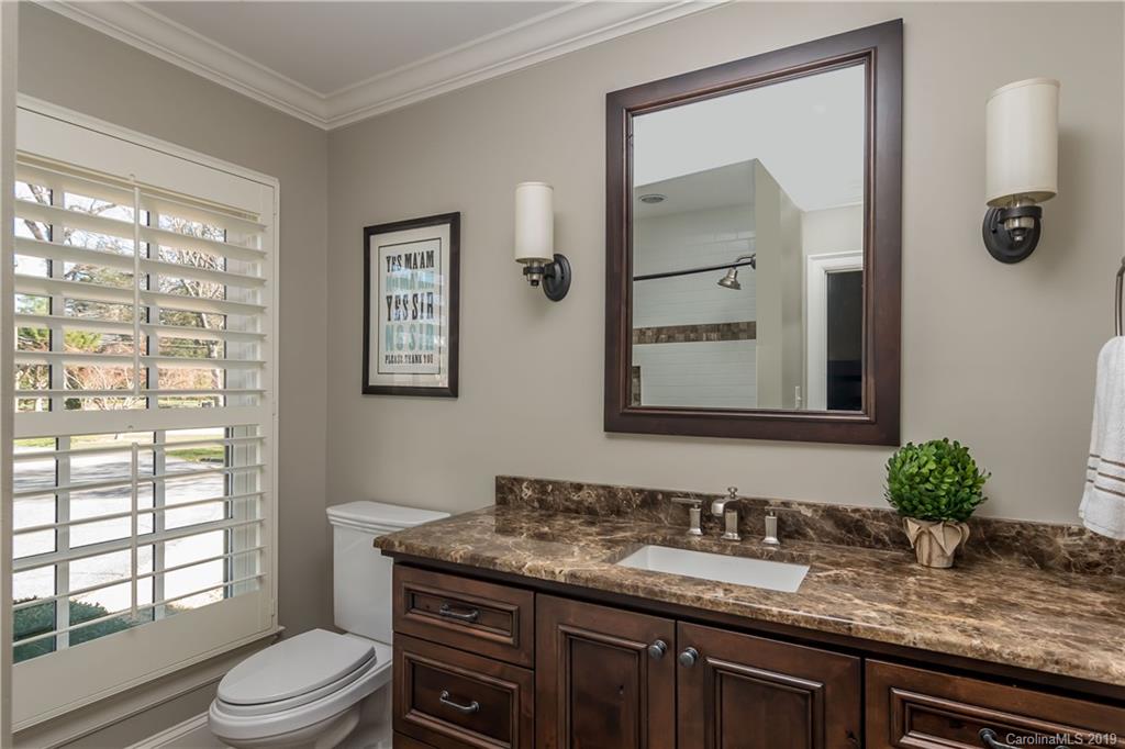 2634 Sharon Road Charlotte, NC 28211 - Photo 29 of 46 a bathroom with a granite countertop sink mirror vanity and toilet